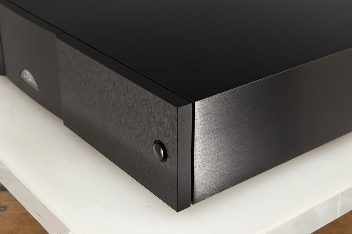 Front right corner of a used Naim CD555PS DR Power Supply in a black finish