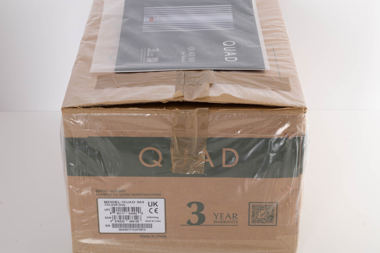 Box for a used Quad 303 Power Amplifier in a Silver finish showing Manual
