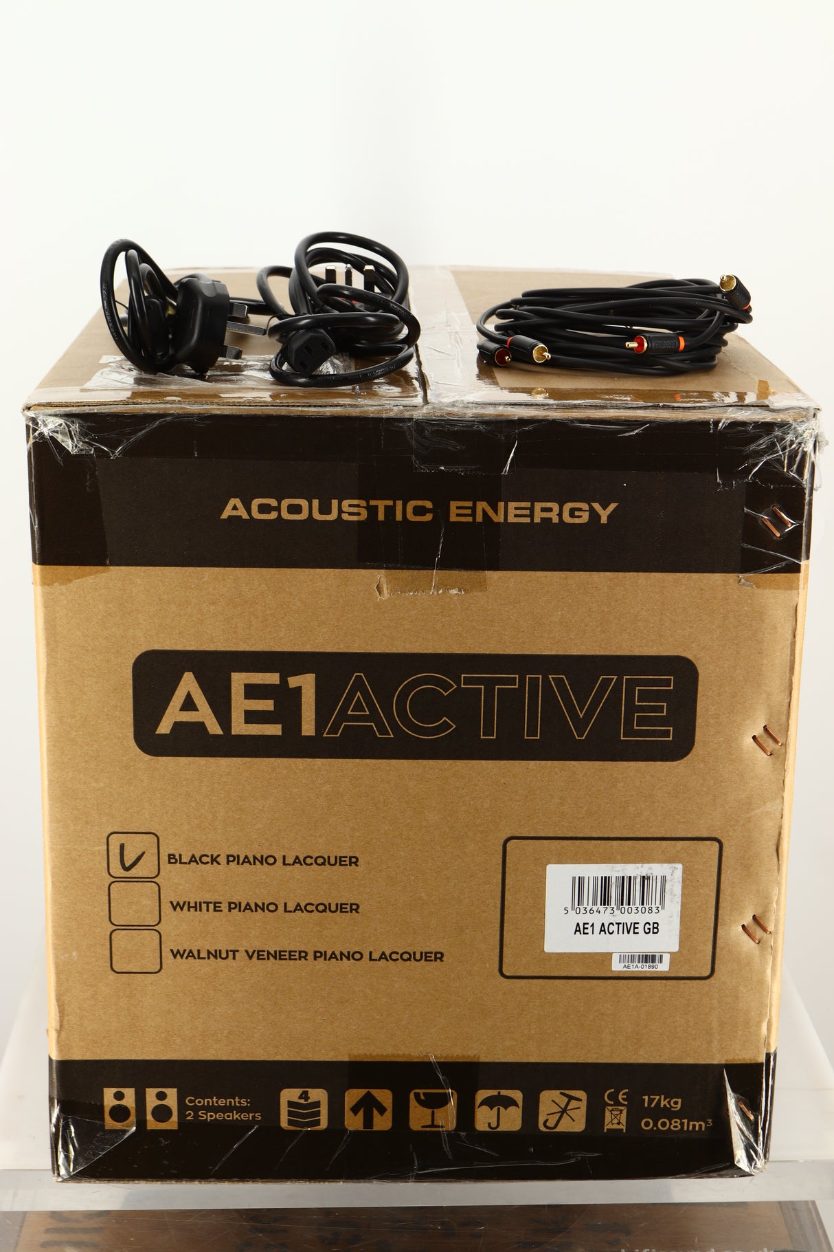 Box of a used Acoustic Energy AE1 Active Standmount Speakers in Black Piano Lacquer finish showing mains cables, and interconnects