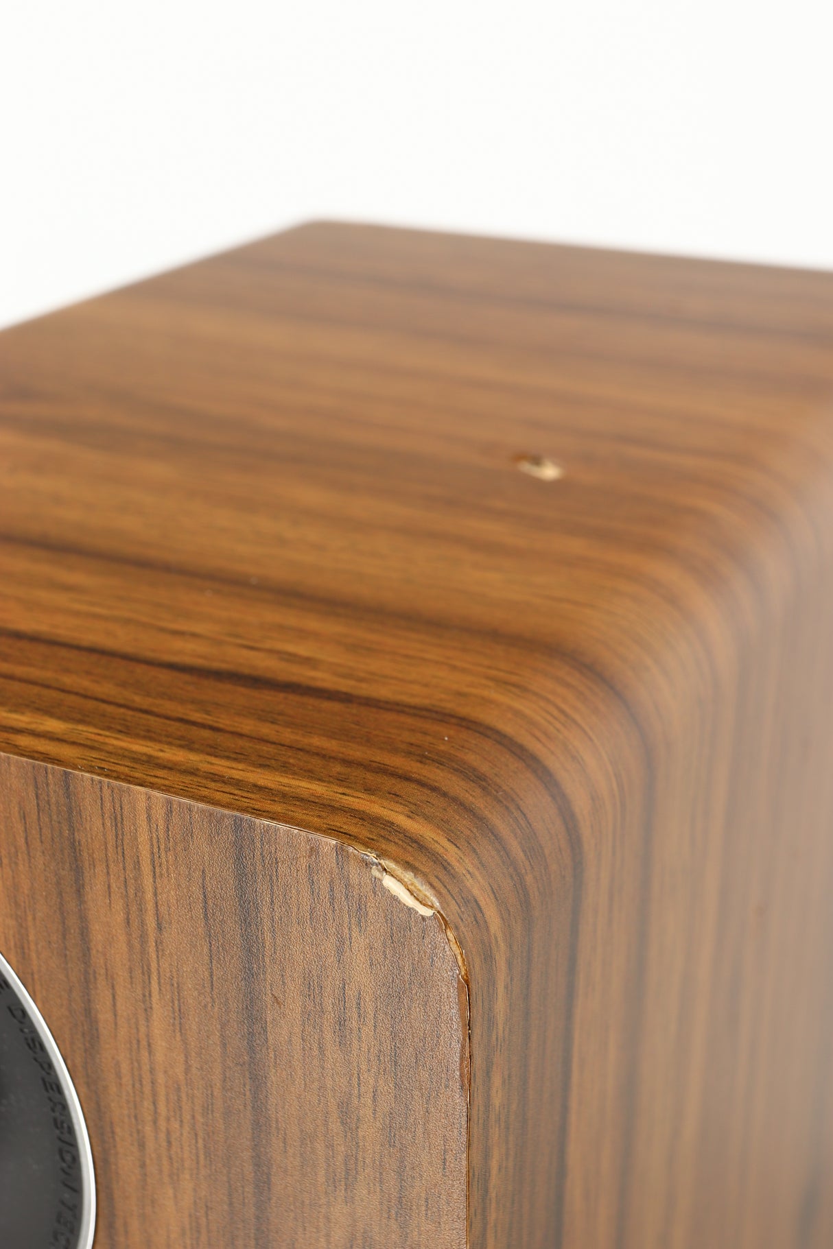 Close up of a used Acoustic Energy AE109 Series Floorstanding Speaker in a walnut finish showing some damage