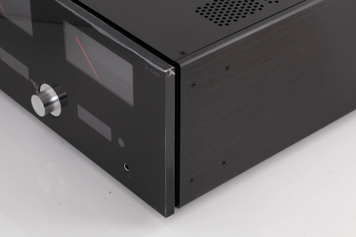 Front right corner of a used Advanced Paris X-i1100 Integrated Amplifier in a Black finish