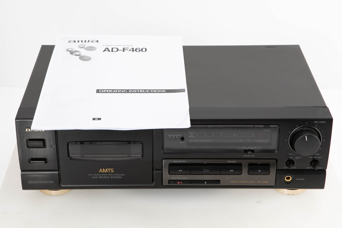 Front view of a used Aiwa AD-F460 Cassette Deck with manual