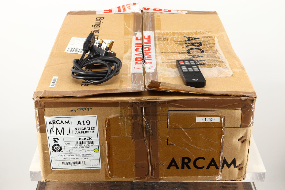 Box of a used Arcam A19 Integrated Amplifier in Black finish showing the remote and mains cable