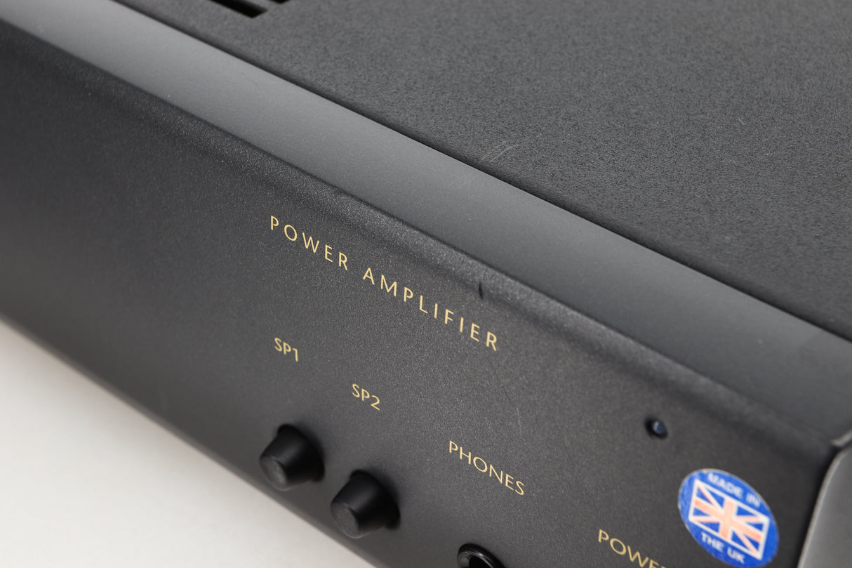 Close up view of a used Arcam Alpha 10 Power Amplifier showing scratching on the fascia and edge