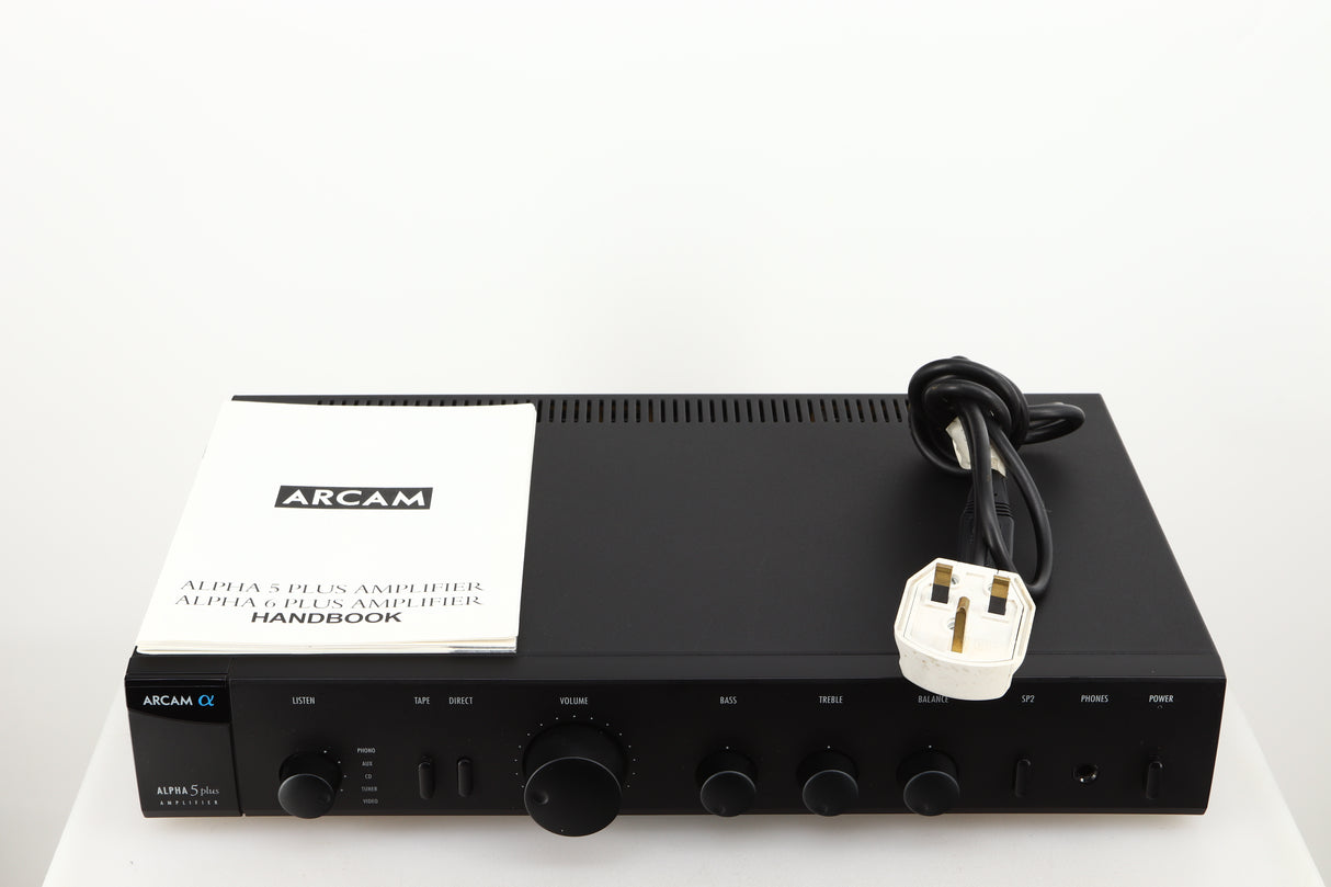 Top of a used Arcam Alpha 5 Plus Integrated Amplifier in a black finish showing Manual and Mains Cable