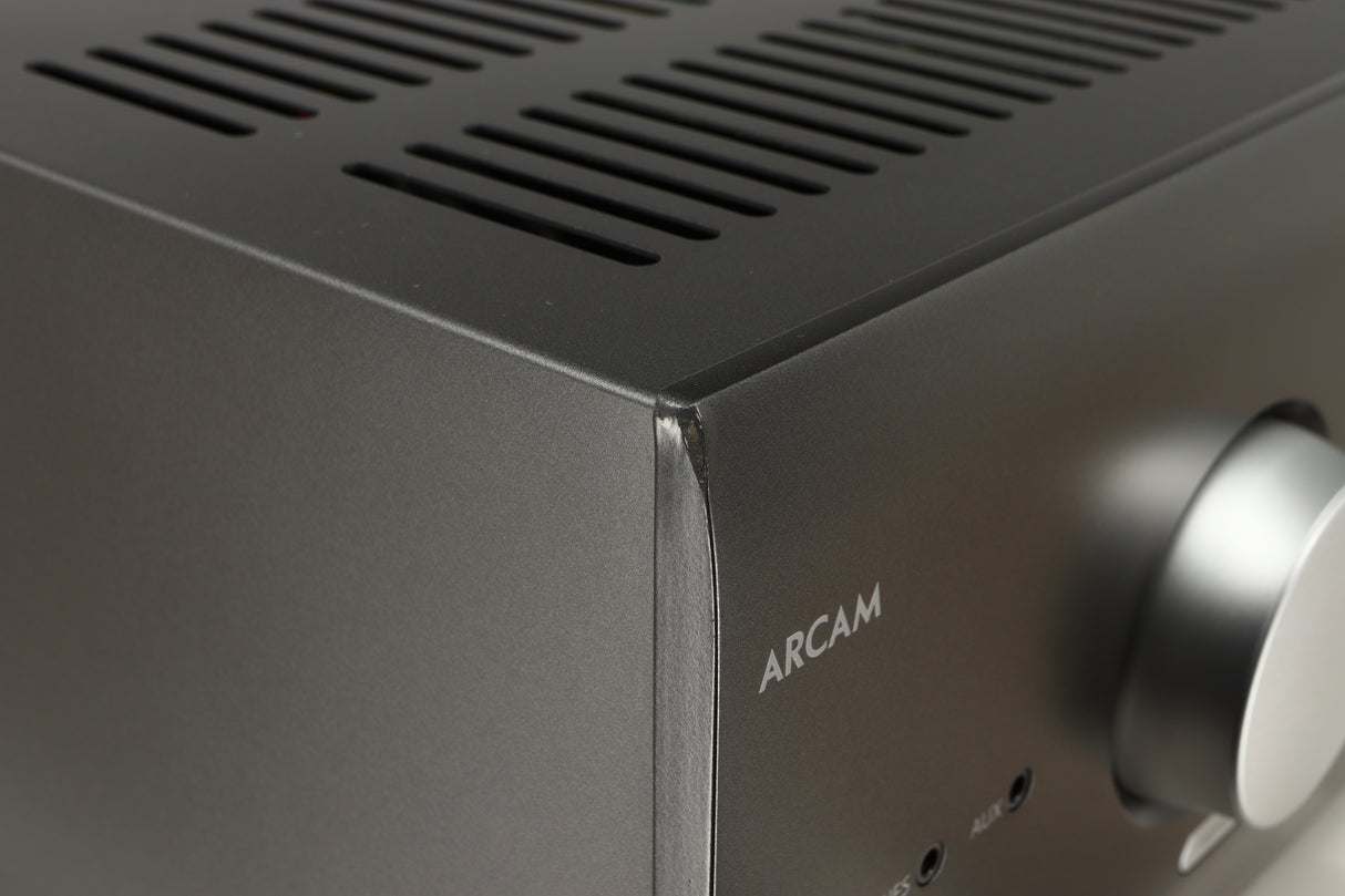 Close up of a used Arcam AVR30 AV Amplifier in a grey finish showing dink on front left corner