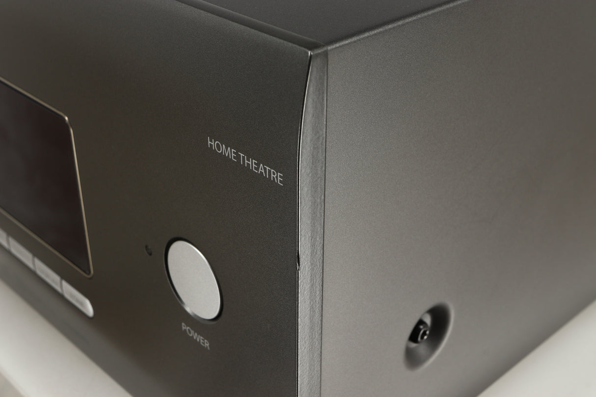 Close up of a used Arcam AVR30 AV Amplifier in a grey finish showing nick on front right corner