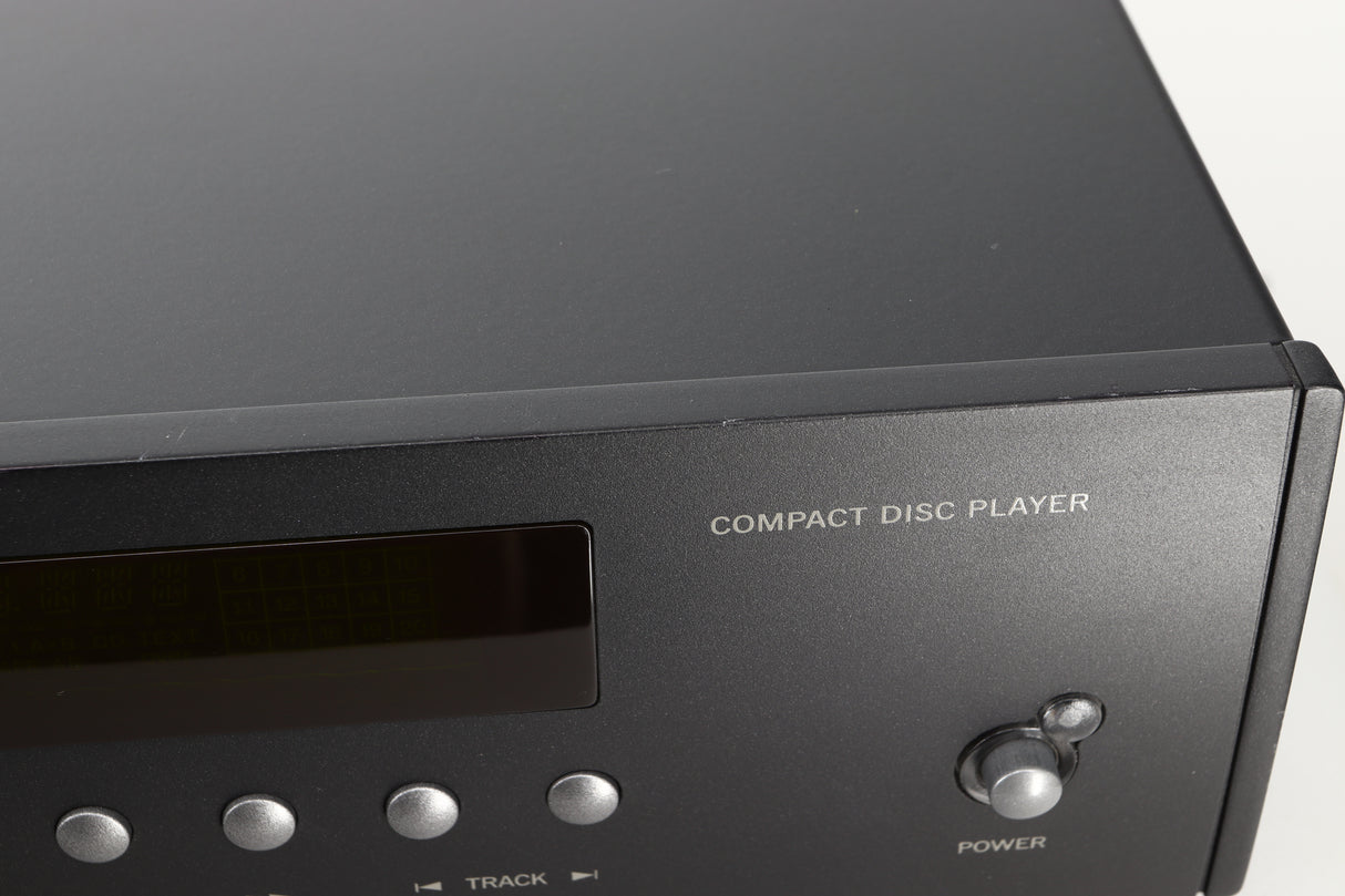 Close up view of a used Arcam CD73T CD Player in Black finish showing some small dents and scratches on the front edge