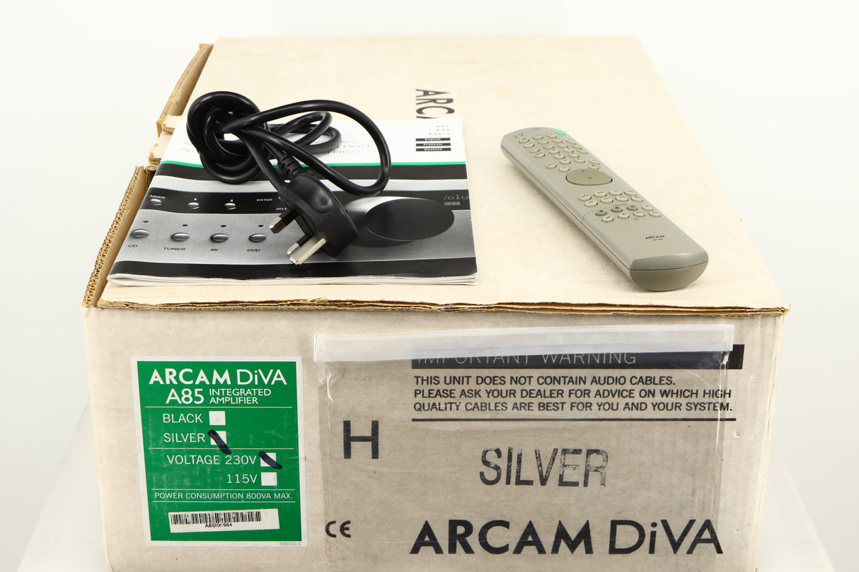 Box for a used Arcam Diva A85 Integrated Amplifier in a silver finish showing Manual, Mains Cable and Remote