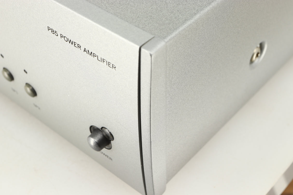Close up of a used Arcam P85/3 Power Amplifier in a silver finish showing scratch on fascia