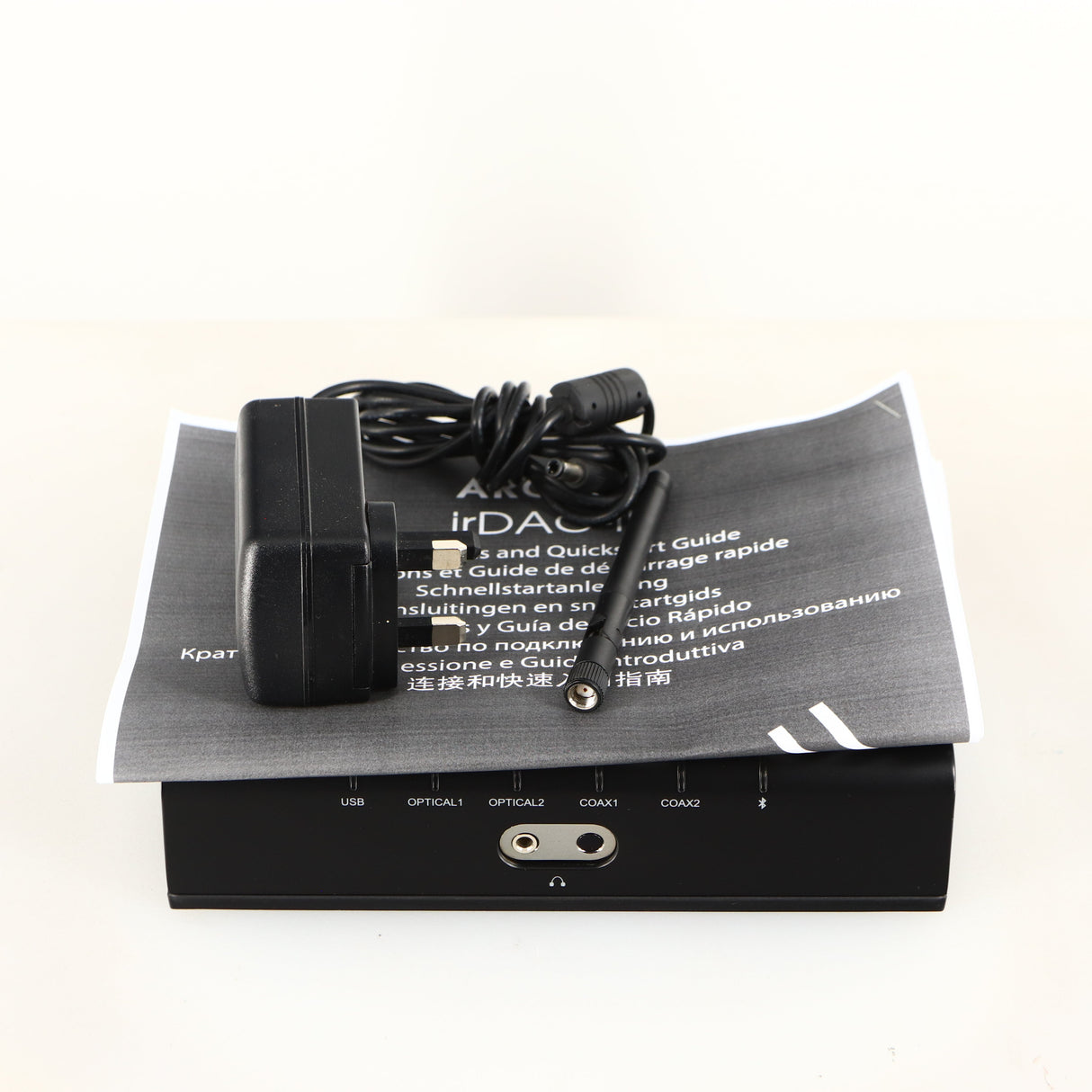 Top of a used Arcam ir-DAC-II Digital Analogue Converter in a black finish showing PSU, Manual and Antenna