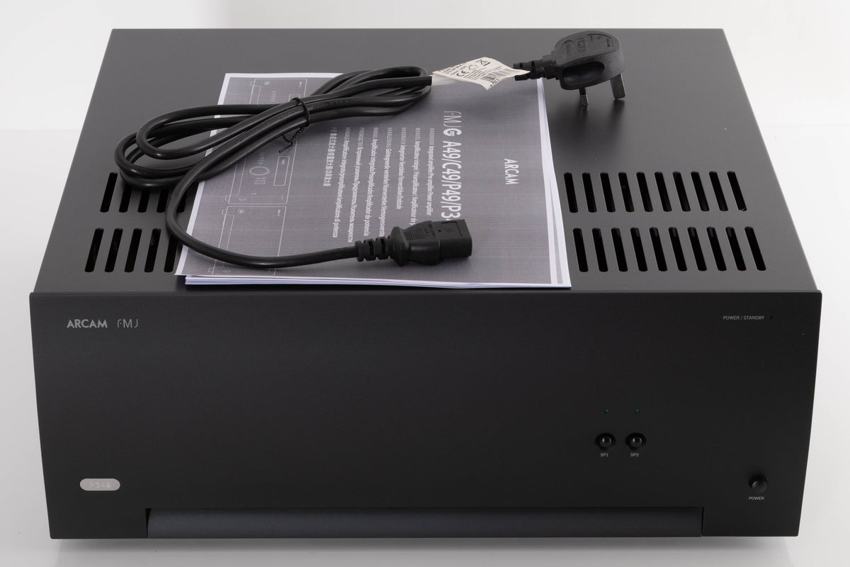 Top of a used Arcam P349 Power Amplifier in a Black finish showing Manual and Mains Cable