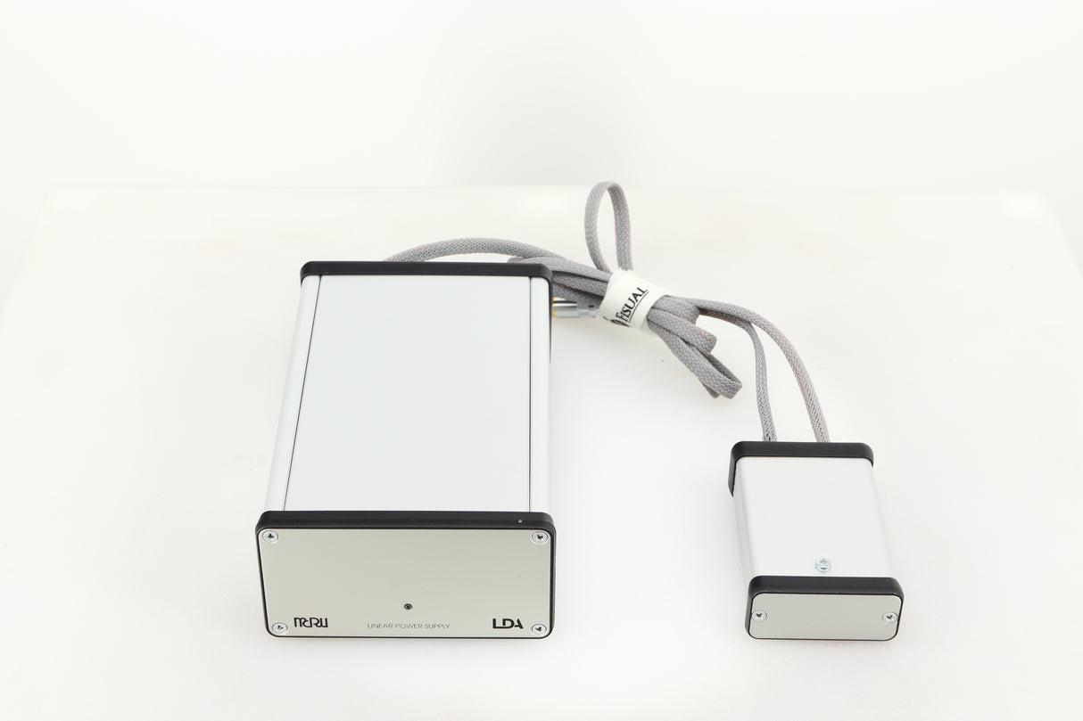Top of a used MCRU Power Supply in a silver finish