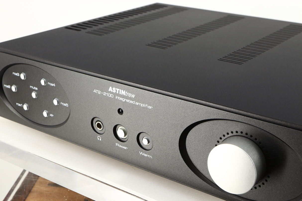 Close up of a used Astin Trew AT2-2100 Integrated Amplifier in a black finish showing some of the fascia
