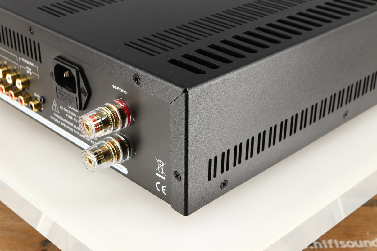 Rear left corner of a used Astin Trew AT2-2100 Integrated Amplifier in a black finish