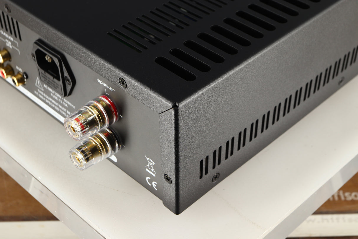 Rear left corner of a used Astin Trew AT2-2100 Integrated Amplifier in a black finish