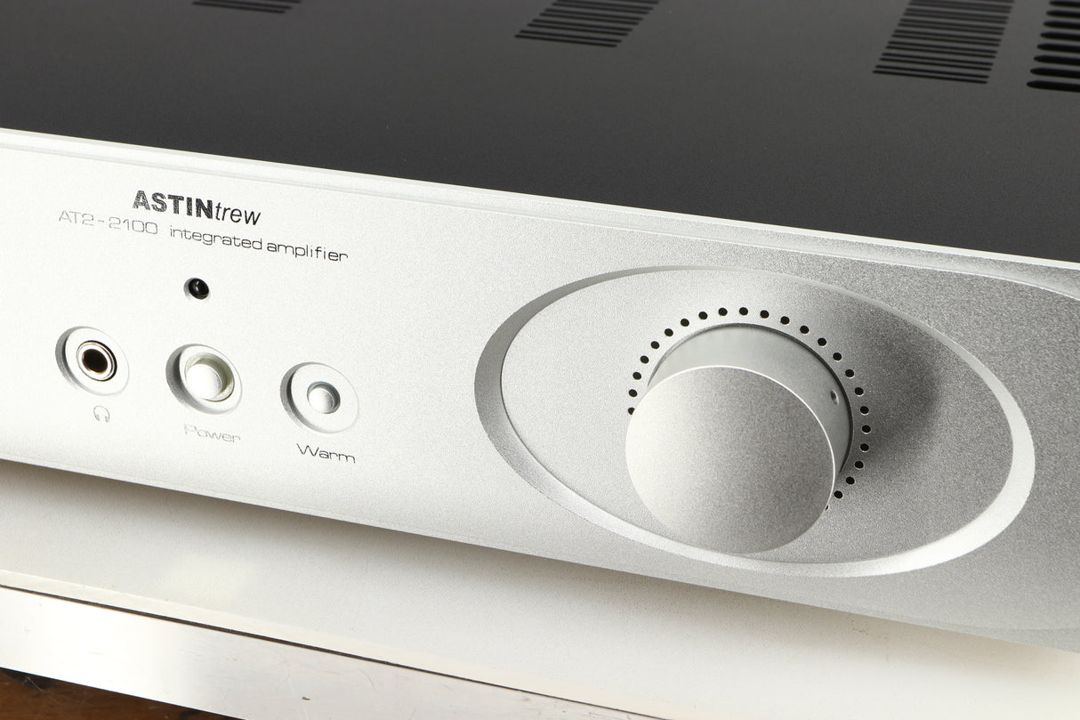 Close up of a used Astin Trew AT2-2100 Integrated Amplifier in a silver finish showing some of the fascia