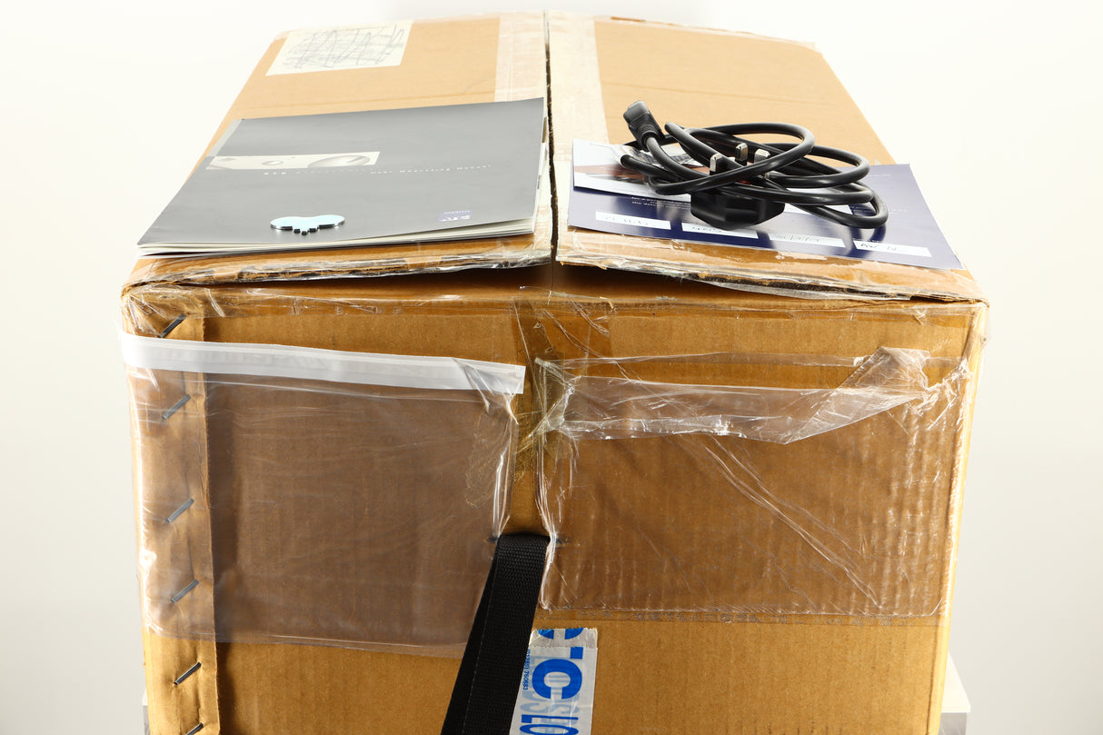 Box of a used ATC P1 Power Amplifier in silver finish showing manual and mains cable