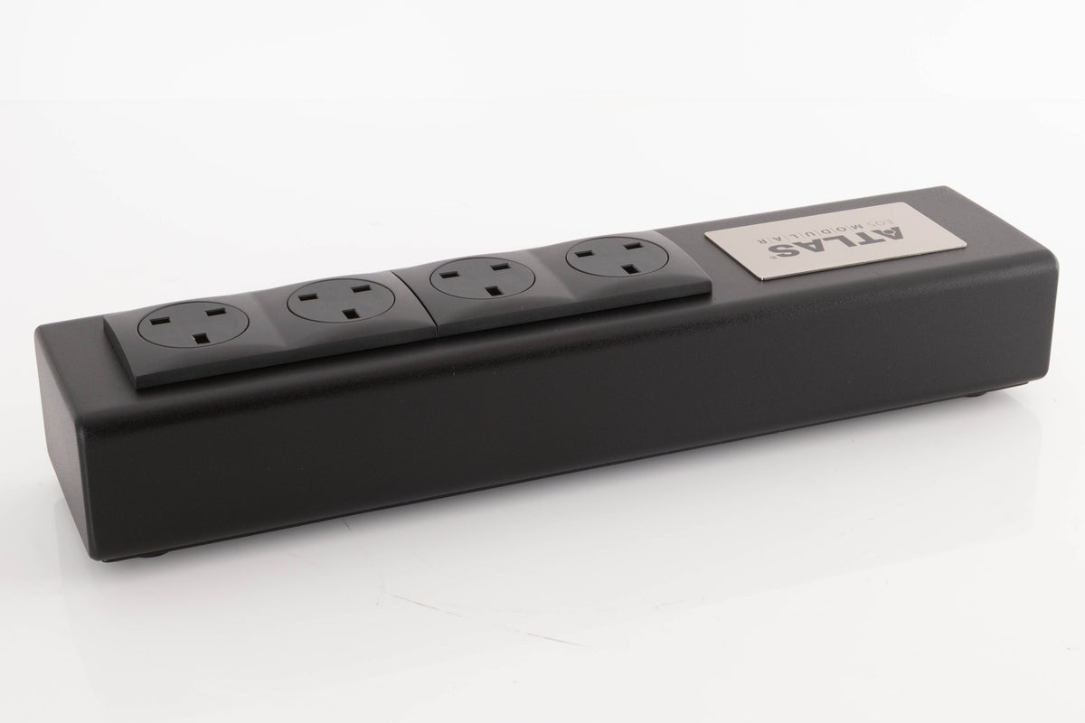 Rear right corner of a used Atlas EOS Modular 4-Way Mains Block in a Black finish