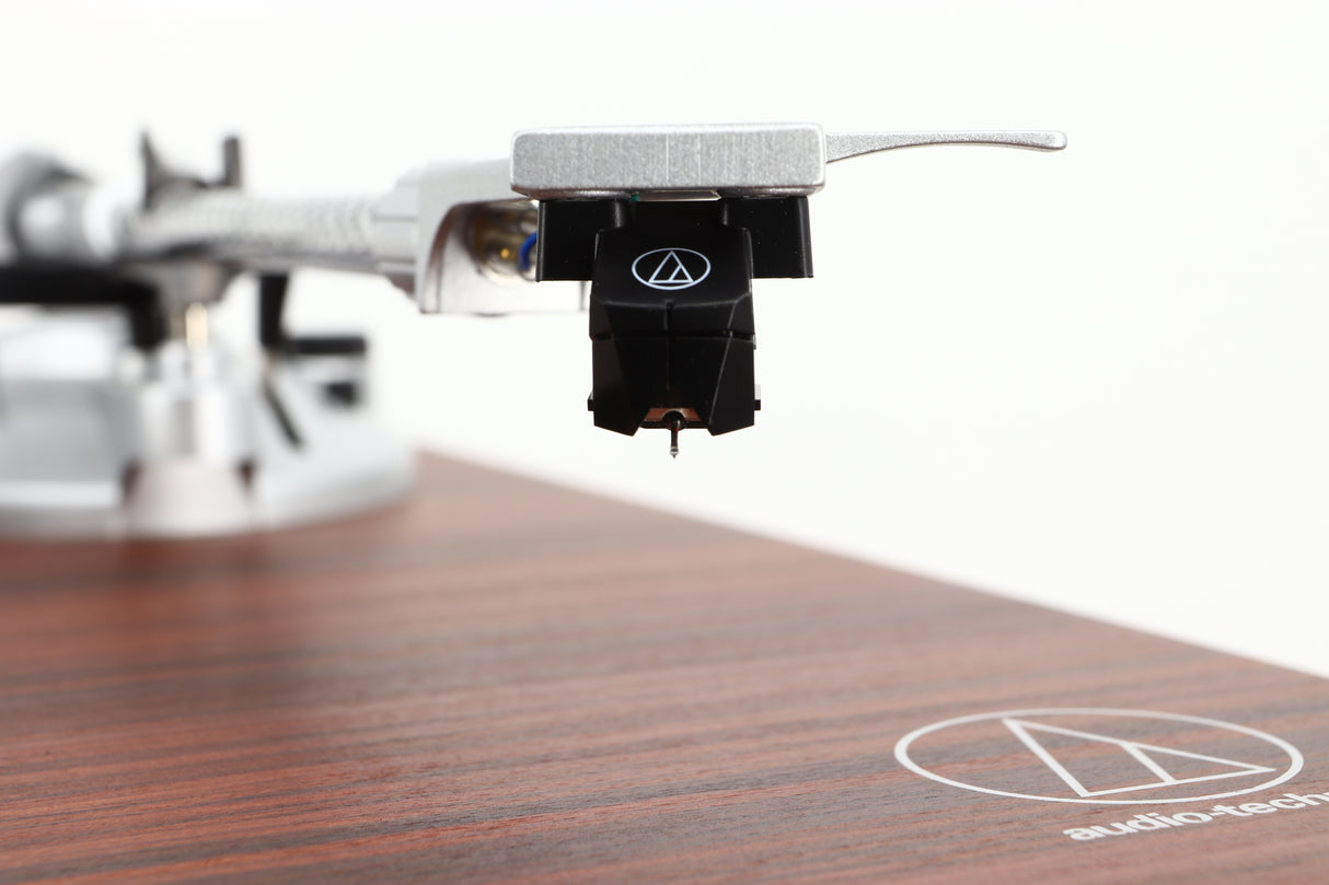 Close up view of a used Audio Technica AT-LPW50BT Turntable in Rosewood finish showing the cartridge