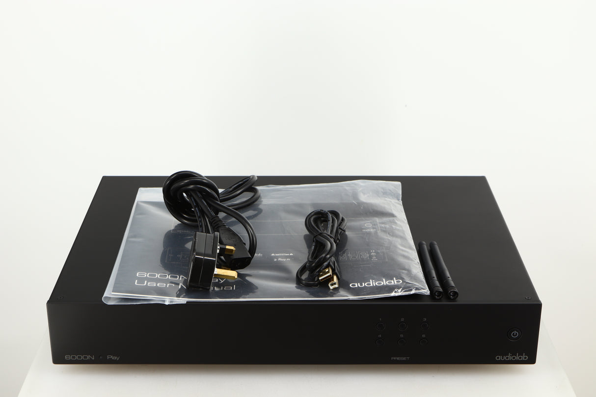 Top of a used Audiolab 6000N Network Streamer in a black finish showing Mains Cable, Manual, 2x Wi-Fi Aerials and USB Cable
