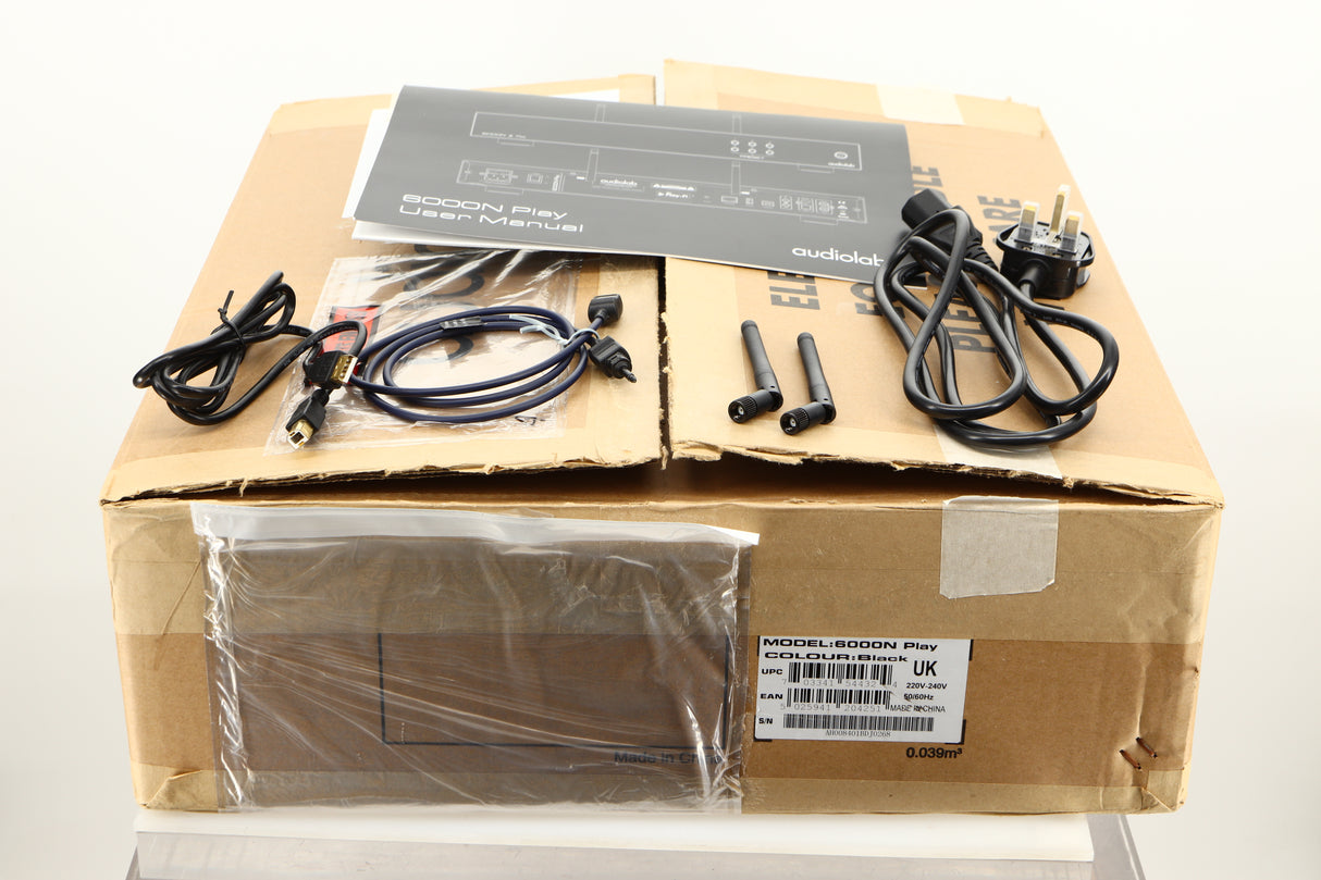 Box of a used Audiolab 6000N Streamer in Black finish showing Mains Cable, Manual, USB Cable, Optical Cable, and 2x Antenna