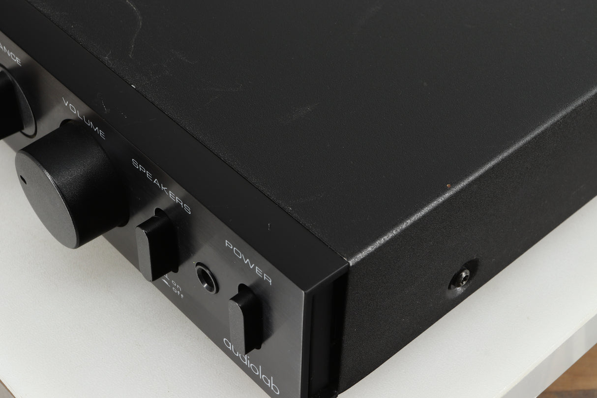 Close up of a used Audiolab 8000A Integrated Amplifier in a black finish showing some damage