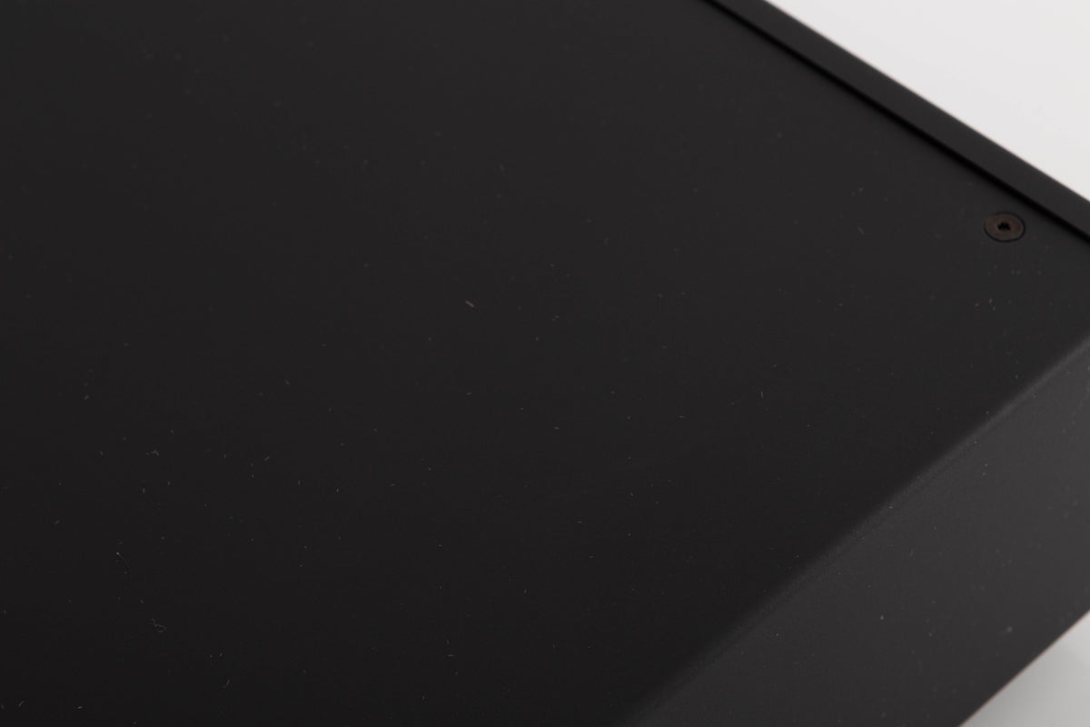 Close up of a used Audiolab DC Block 6 in a Black finish showing some scratches on top