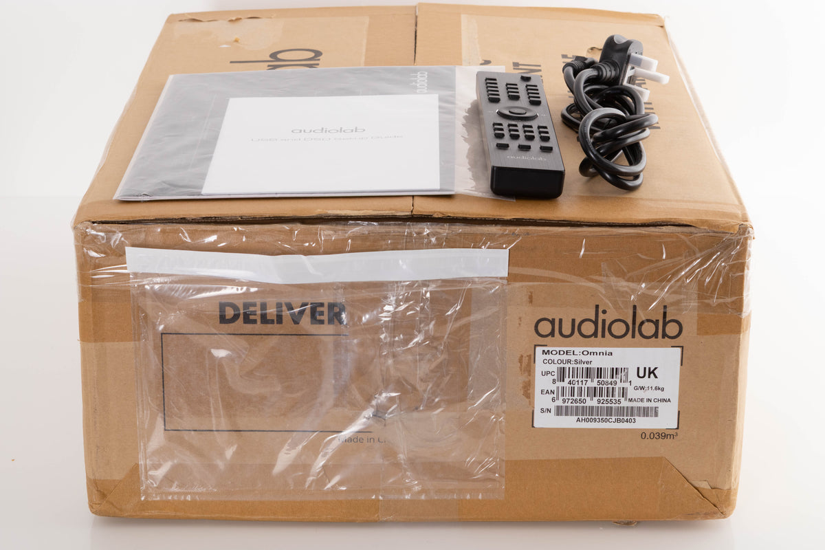 Box of a used Audiolab Omnia Integrated Streaming System in Silver with mains cable, manual, and remote