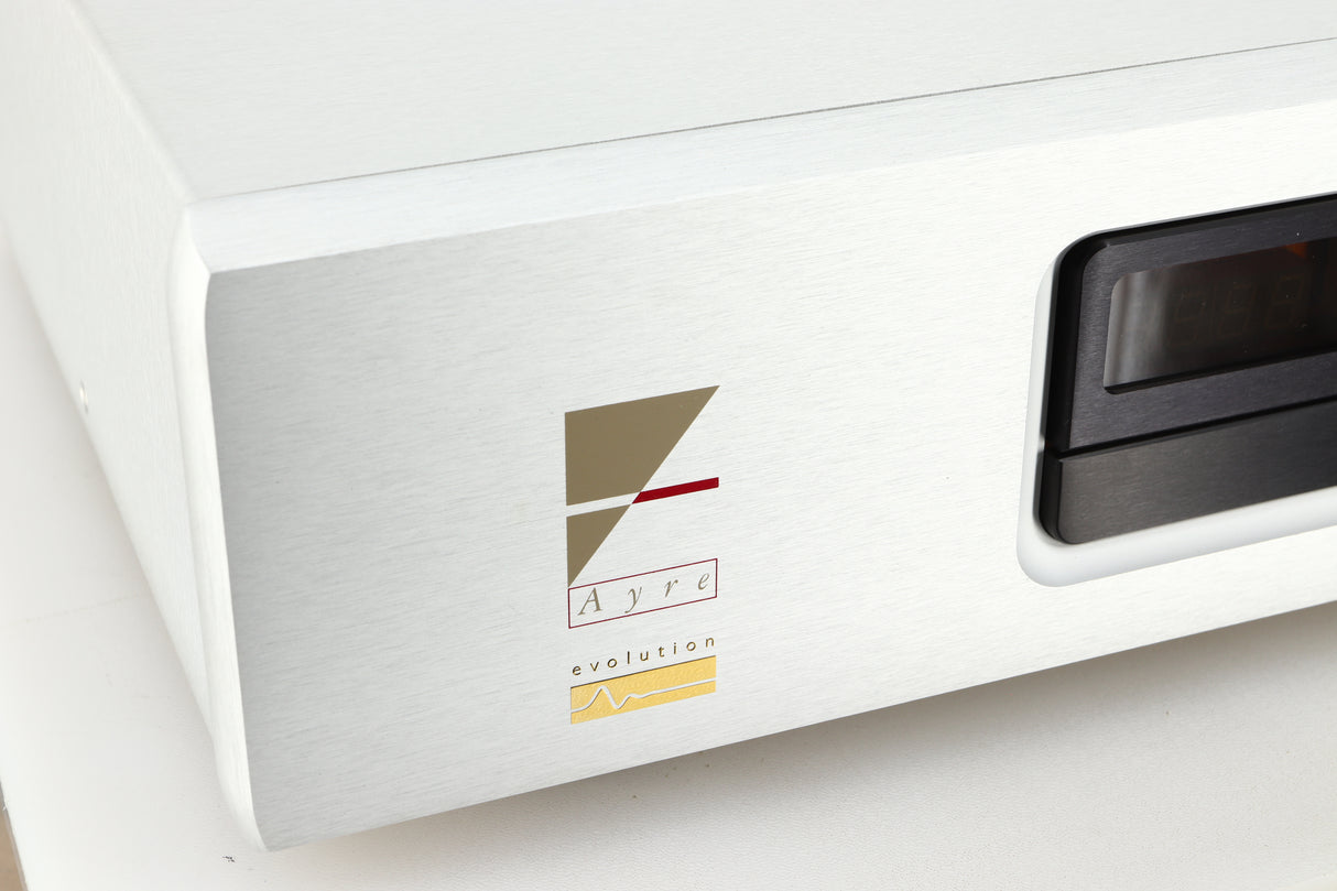 Close up view of a used Ayre CX-7 CD Player in silver finish showing the logo