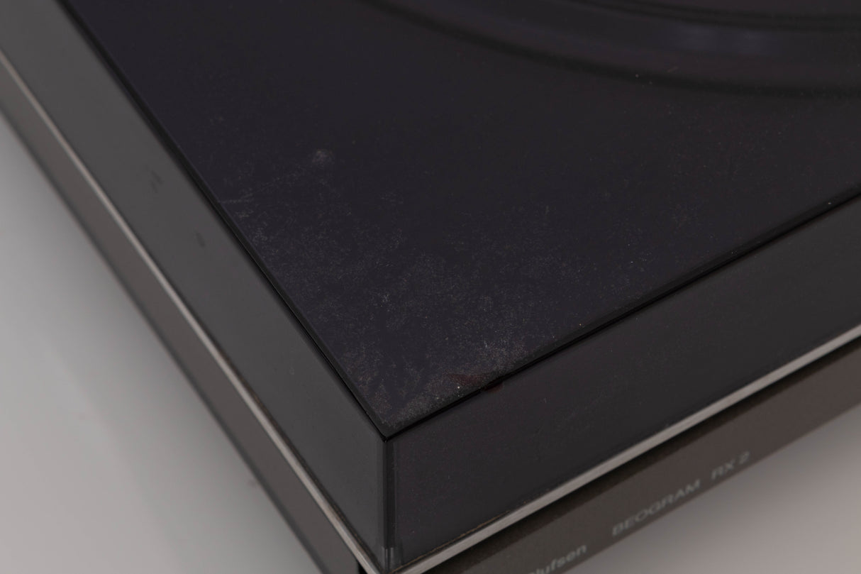 Close up of a used B&O Beogram RX2 Turntable showing some damage on lid