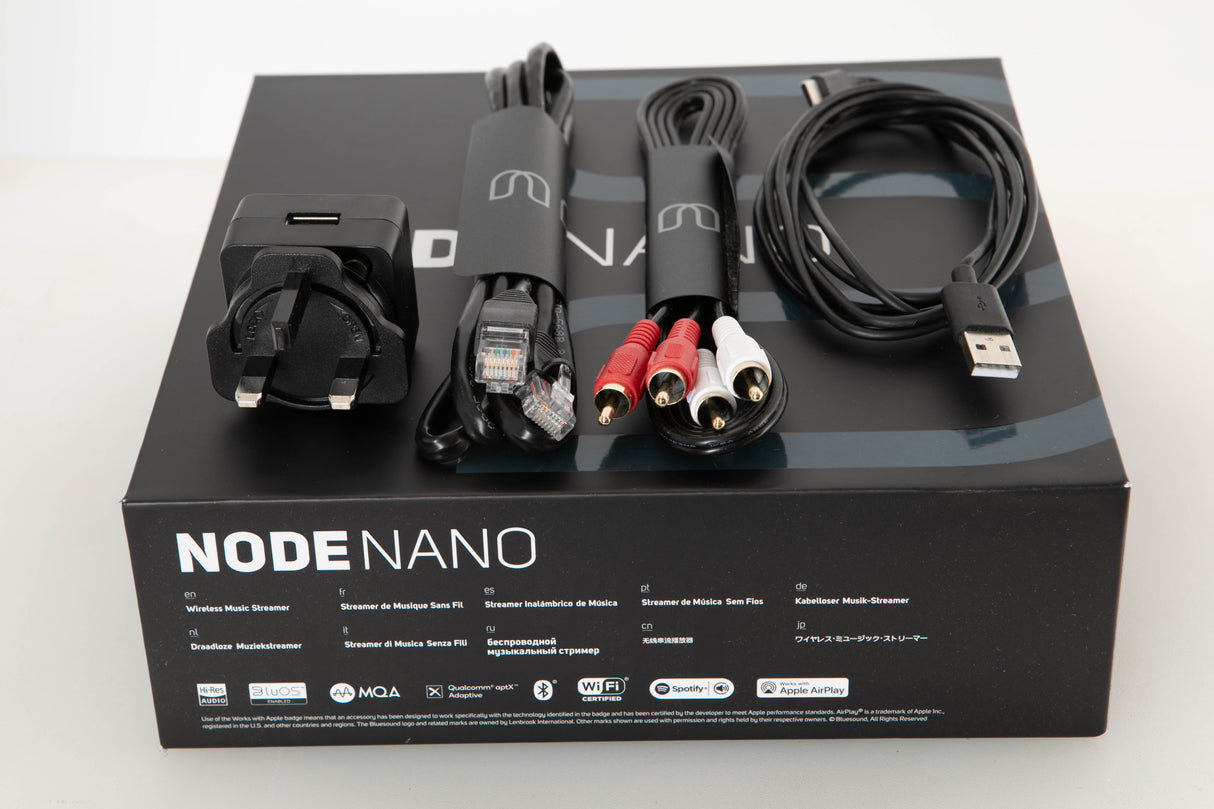 Box of a used Bluesound Node Nano Streamer with Mains Adaptor, Ethernet Cable, USB Cable, RCA Cables, and Manual