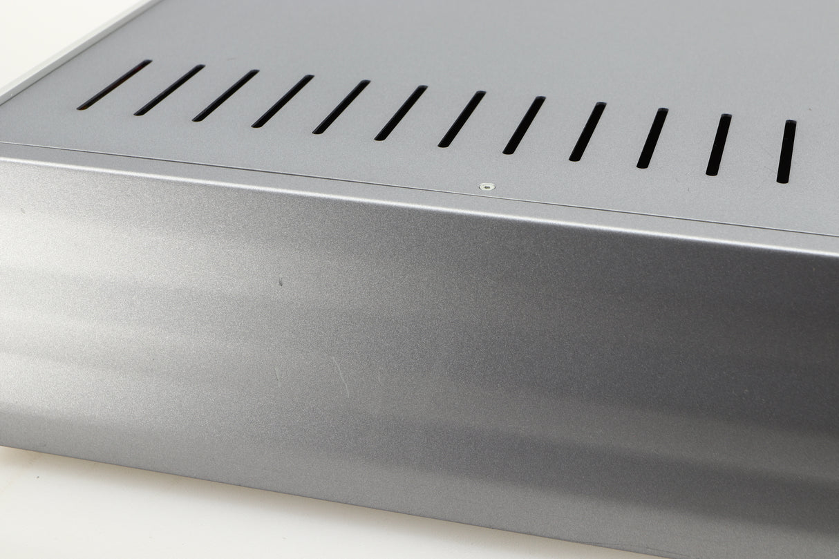 Close up of a used Cambridge Audio Azur 640A Integrated Amplifier in a silver finish showing scratching on right side