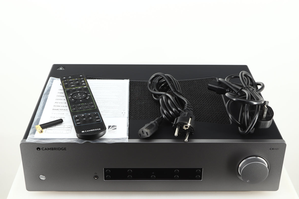 Top of a used Cambridge Audio CXA81 GEN2 Integrated Amplifier in a lunar grey finish showing Remote, Bluetooth Antenna, Mains Cable, Schuko Cable and Manual