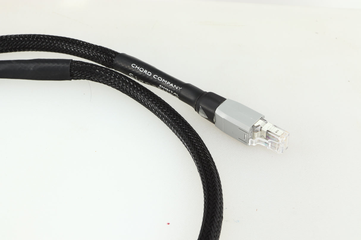 Close up of a used Chord Company Signature Super Aray Digital Streaming Cable 1.0m in a black finish showing the connector