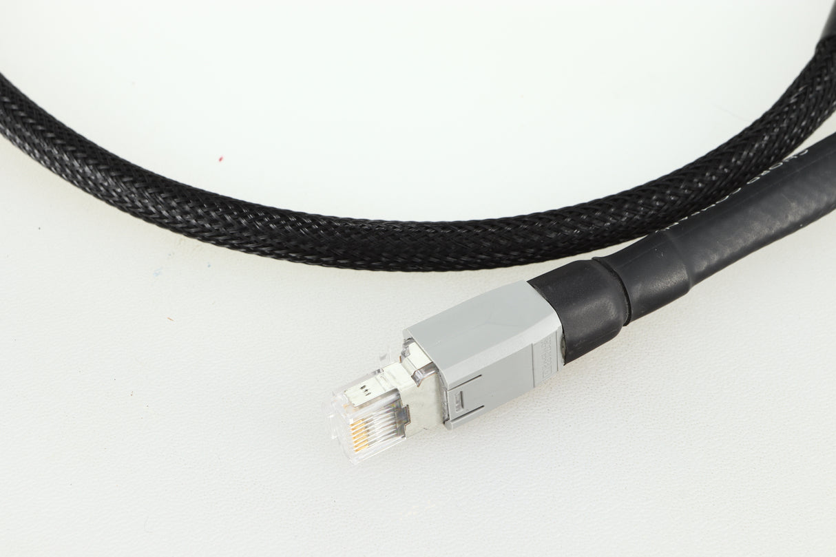 Close up of a used Chord Company Signature Super Aray Digital Streaming Cable 1.0m in a black finish showing the connector