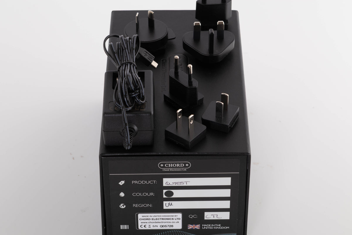 Box for a used Chord Electronics Qutest Digital Analogue Converter in a Black finish showing PSU, Mains Plug and Schuko Plug