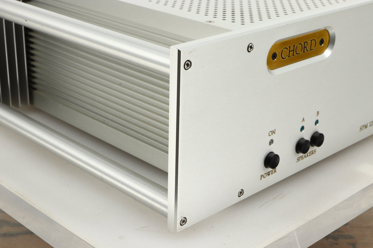 Front left corner view of a used Chord Electronics SPM1200C Power Amplifier in Silver finish