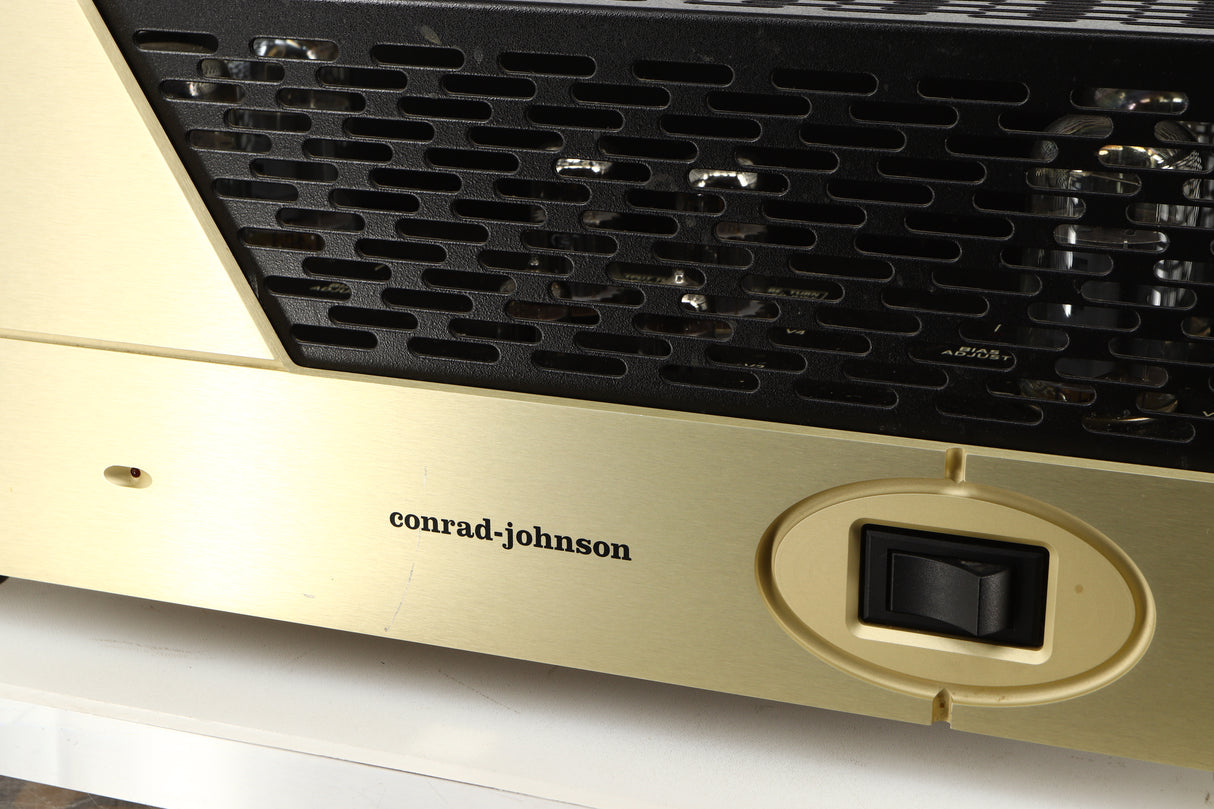 Close up of a used Conrad Johnson MV60SE Power Amplifier showing scratch on fascia