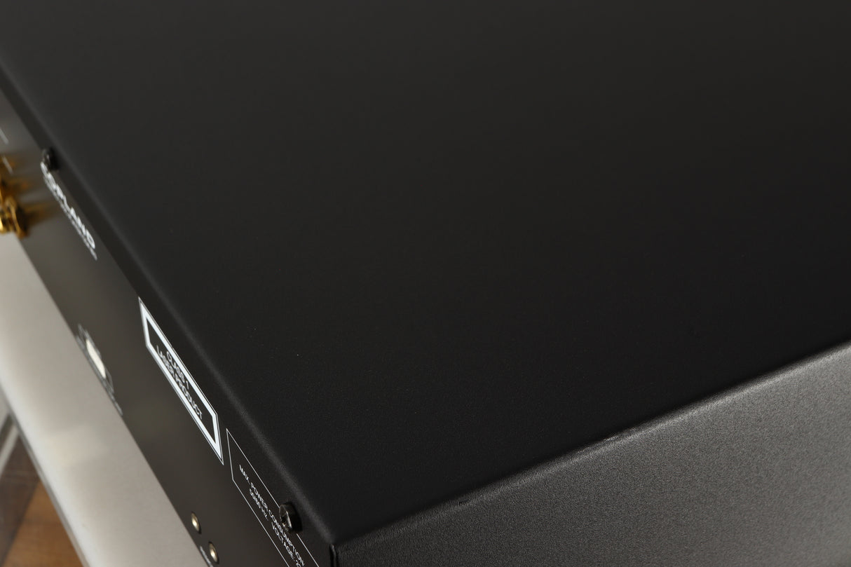 Close up of a used Copland CDA823 CD Player in a silver finish showing scratching on left side edge