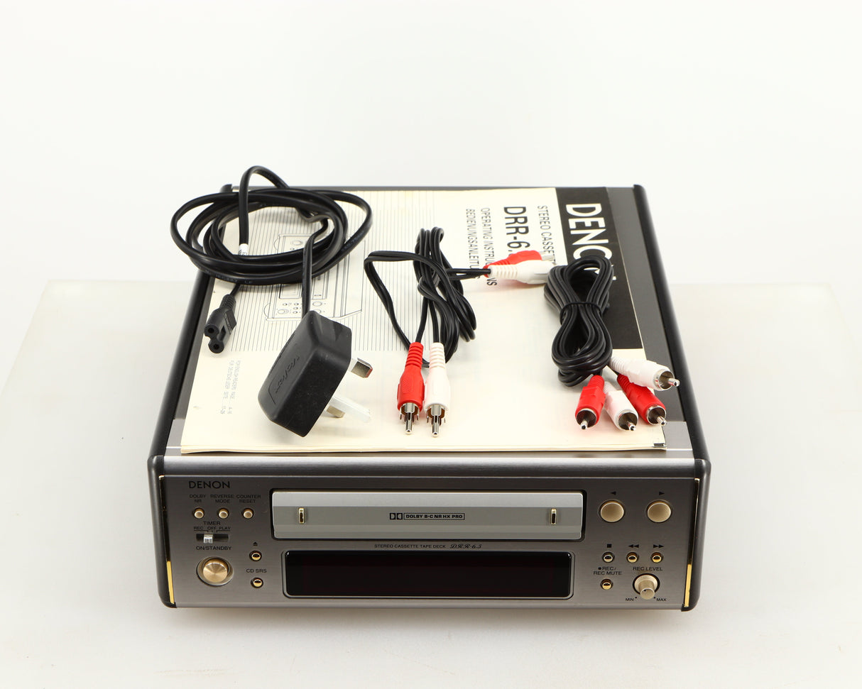 Top of a used Denon DDR-6.5 Cassette Deck in a silver finish showing Manual, 2x Interconnect Cables and Power Cable