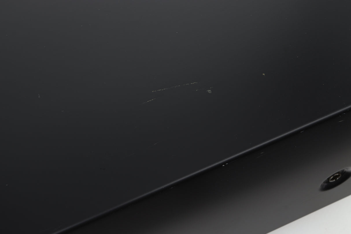 Close up view of a used Denon PMA-720 Integrated Amplifier in Black finish showing scratches on the top near the right side