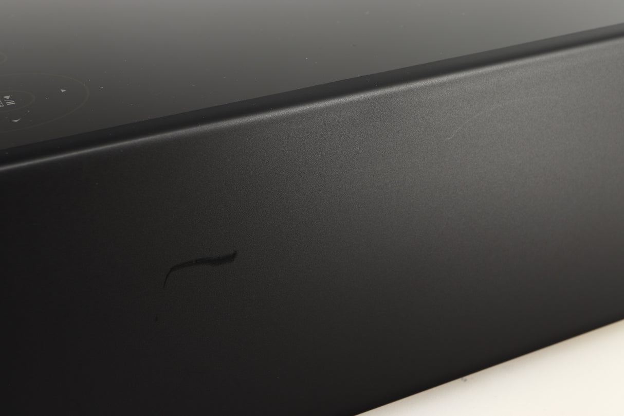 Close up of a used Denon RCD-N10 Network CD Receiver in a black finish showing scratches on right side