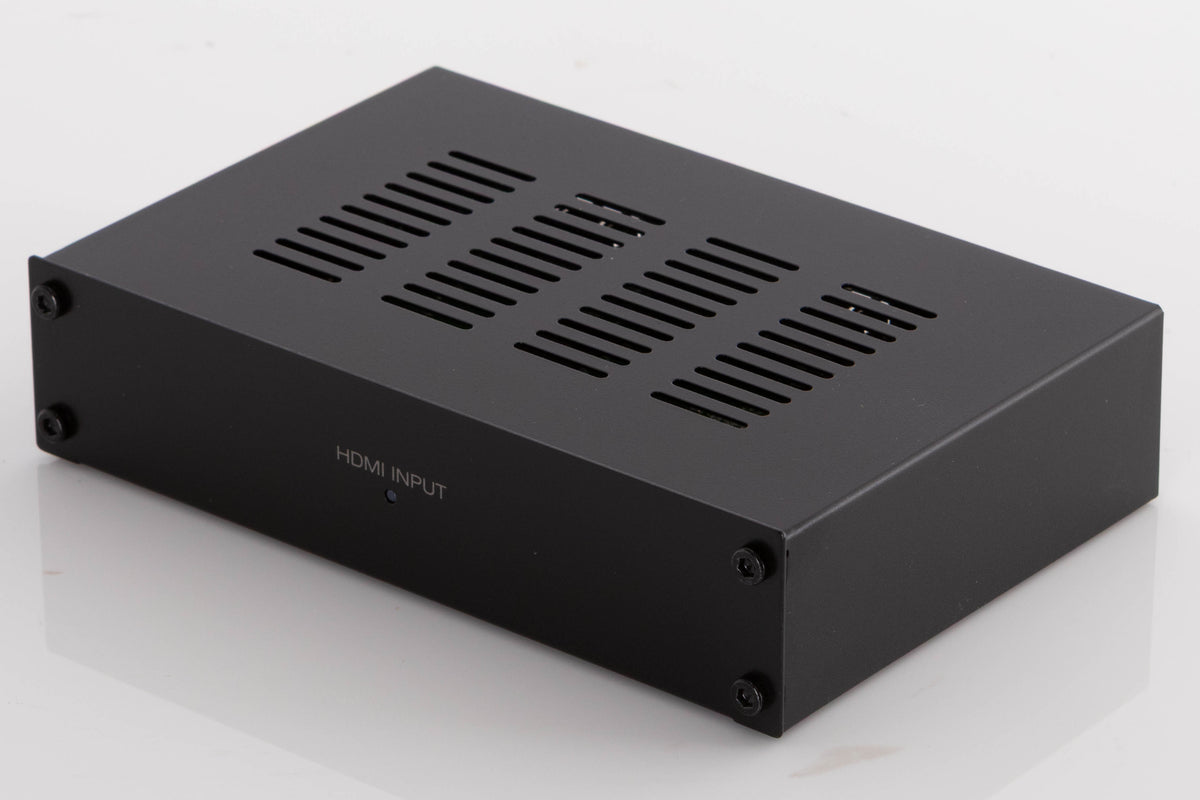 Front right corner of a used Denon SPK618 HDMI Adaptor in a Black finish