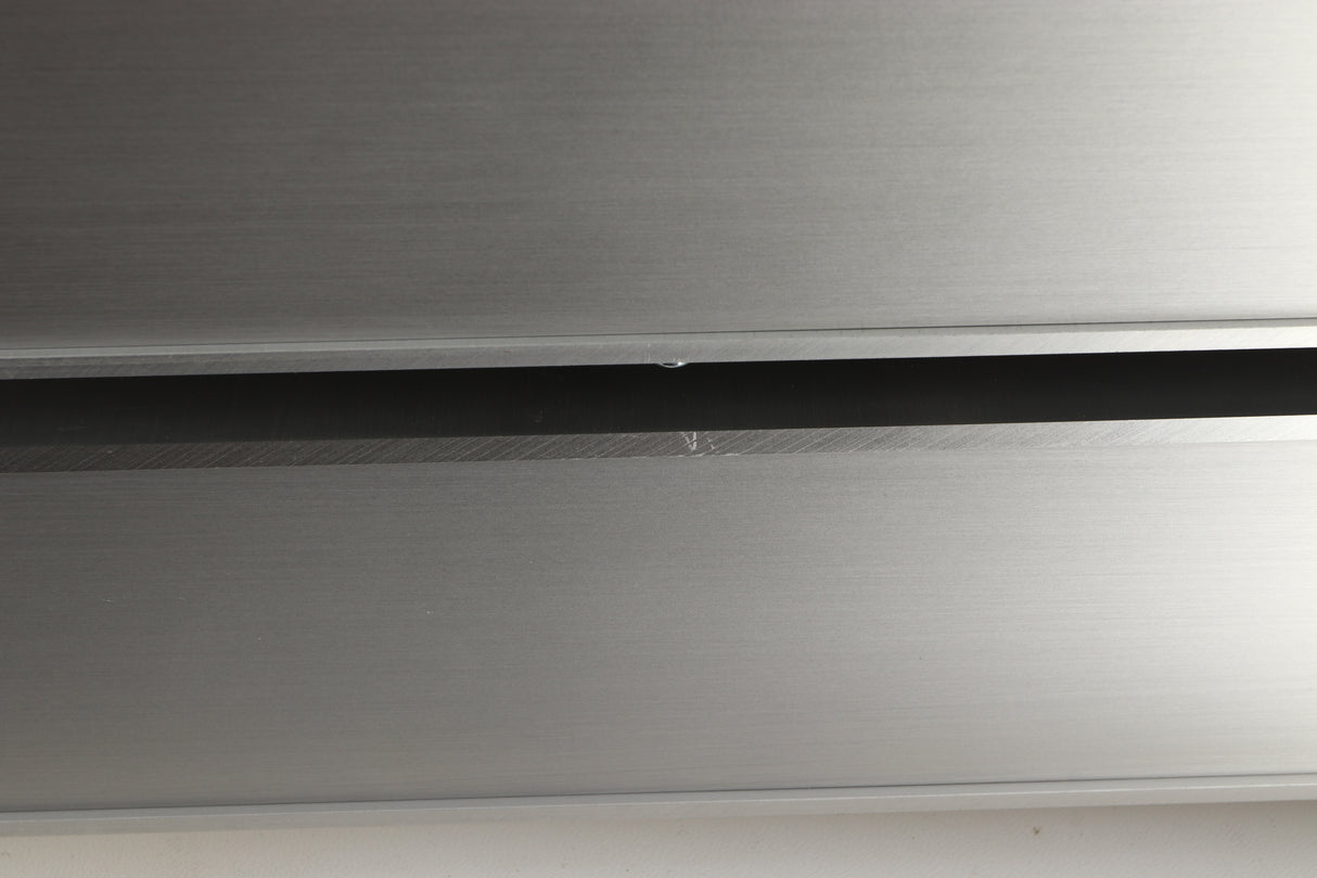 Close up view of a used Densen 2NRG PSU in Albino finish showing a scratch on the right side edge