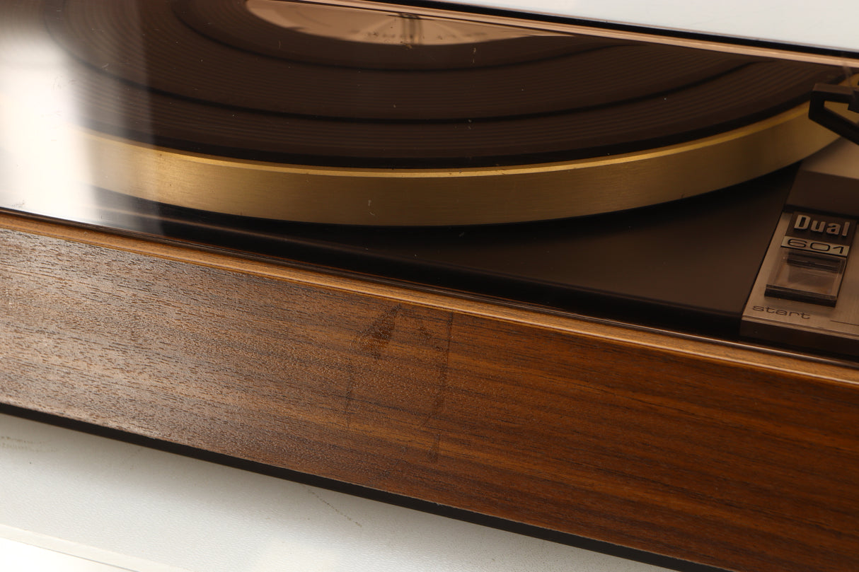 Close up of a used Dual 601 Turntable / Goldring 1042 Cartridge in a walnut finish showing mark on front