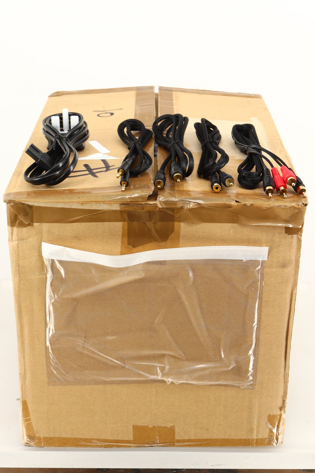 Box of a used pair of Focal XS Book Wireless 2.0 Active Bluetooth Standmount Speakers showing Mains Cable, 3.5mm Cable, M-M RCA Cable, M-F RCA Cable, and Interconnects