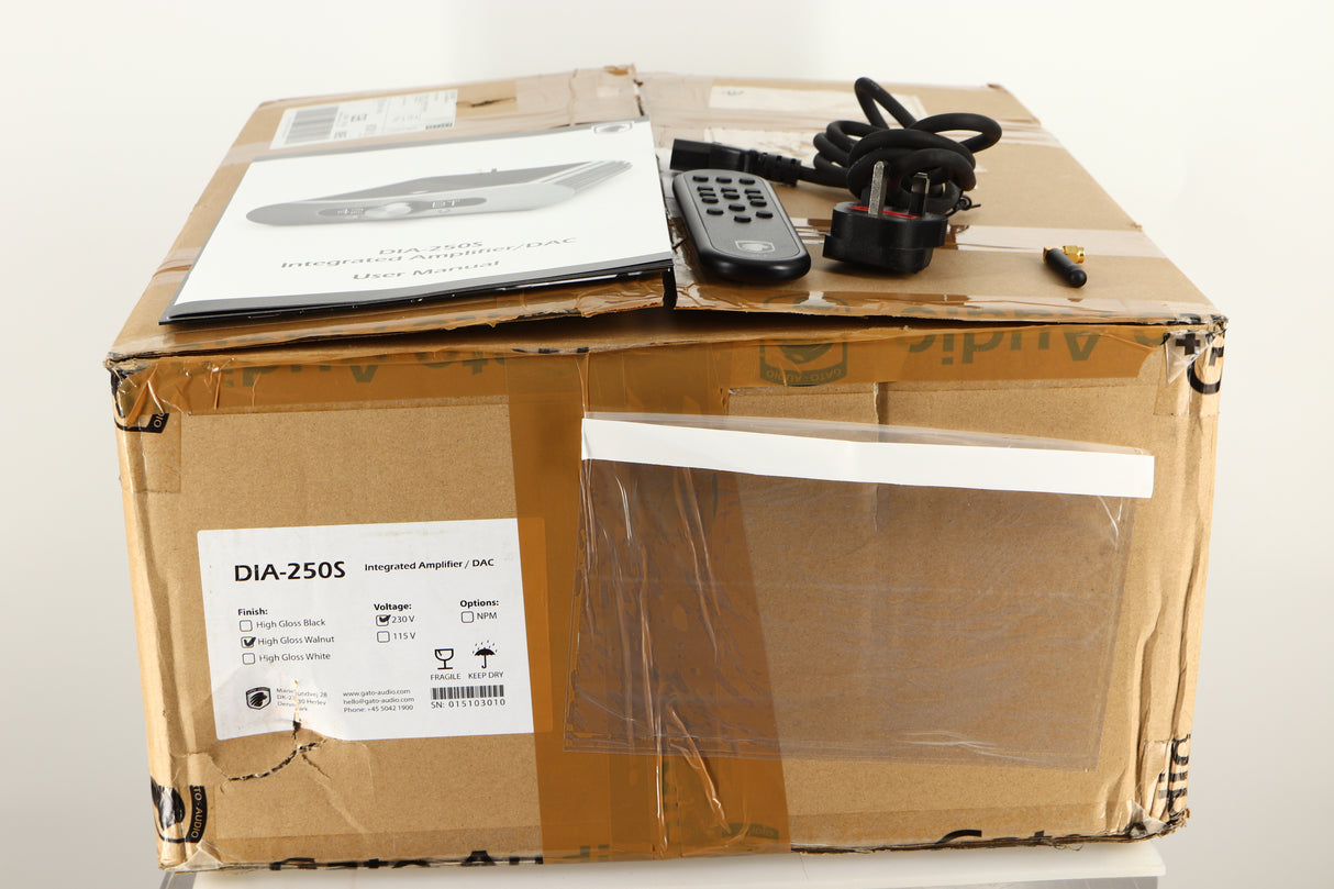 Box of a used GATO DIA-250S Integrated Amplifier in High Gloss Walnut finish with mains cable, manual, remote, and antenna