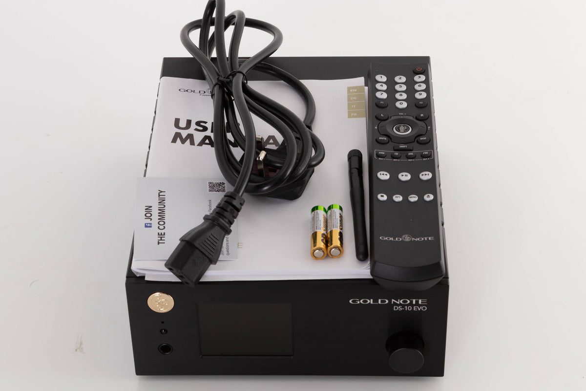 Top of a used Goldnote DS-10 Evo Streaming Digital Analogue Converter in a Black finish showing Remote, Batteries, Manual, Mains Cable and Wi-Fi Antenna