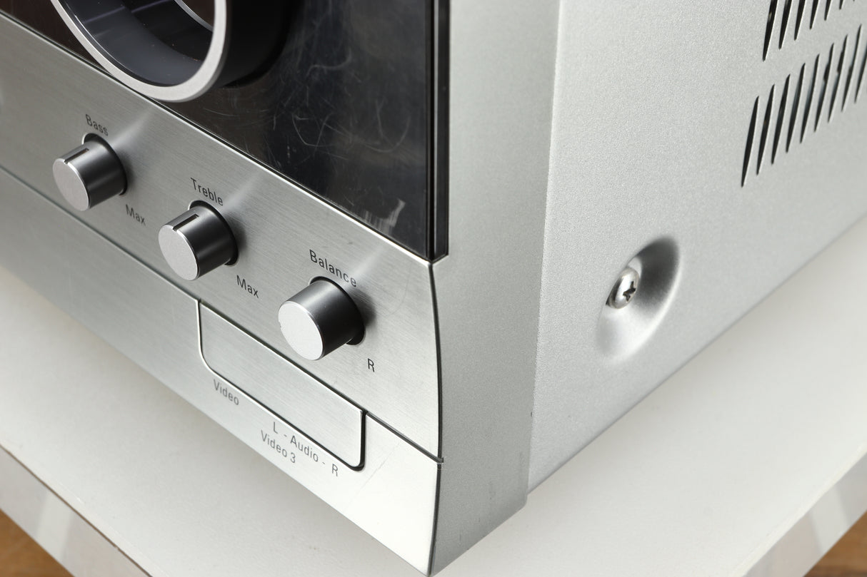 Close up of a used Harman Kardon 3380 Receiver in a silver finish showing more scratching